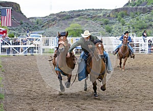 Cowboys competing in Ranch Bronc Riding