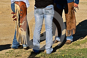 Cowboys and cowgirls in chaps