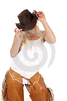 Cowgirl chaps hold hat