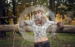 Cowgirl (Cowboy girl) with a cigar in cowboy shirt and hat