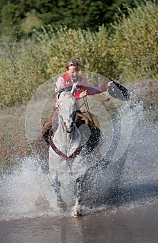 Cowgirl Galloping Through Pond