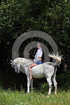 Cowgirl ride back horse in a evening woods