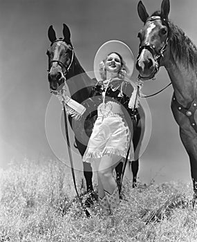 Cowgirl with two horses photo