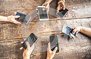 Coworker having using mobile smart phone on wooden background - Close up of people hands sharing content on social media with