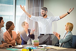 Coworkers applauding a colleague after presentation