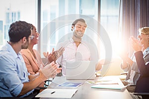 Coworkers applauding a colleague after presentation