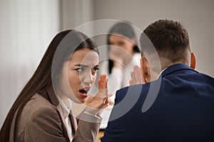 Coworkers bullying their colleague at workplace in office