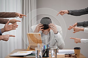 Coworkers bullying their colleague at workplace in office, closeup