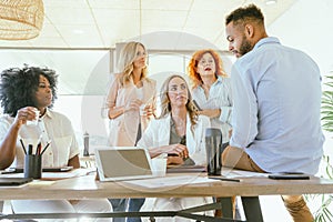 Coworkers discussing ideas for startup project at the office