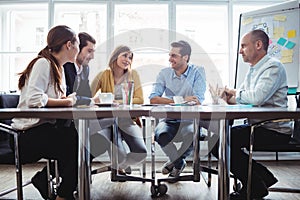 Coworkers discussing in meeting room