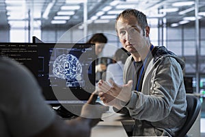 Coworkers doing brainstorming in server hub, using AI tech