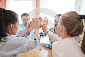 Coworkers doing high five