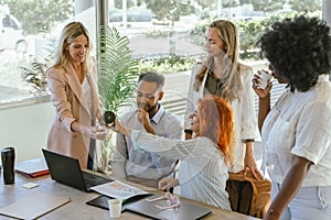 Coworkers drinking coffee while relaxing on a break from work