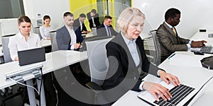 Coworkers engaged in open plan office