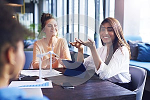 Coworkers having a conversation at office table