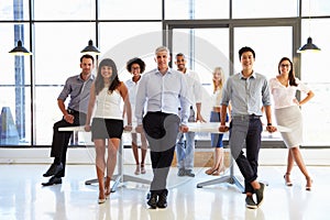 Coworkers posing to camera in meeting room