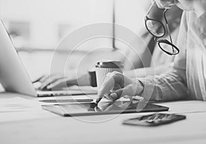 Coworkers team Researching process modern office.Project manager touch tablet screen,holding glasses female hand.Young