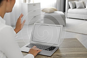 Coworkers working together online. Young woman using video chat on laptop, closeup