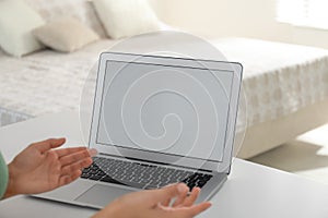 Coworkers working together online. Young woman using video chat on laptop, closeup