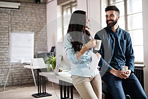 Coworking colleagues having conversation at workplace