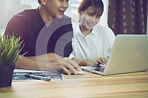 Coworking space, team working together. Modern workplace desks and computers and documents.