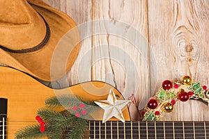 Cowvoy christmas background with guitar and cowboy western hat