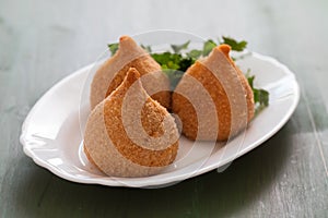 Coxinha de frango, typical brazilian chicken croquette on white dish