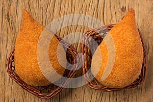 Coxinha is a deep fried food, traditional in Brazil. Two snacks