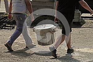 Cozido Stew Stock Pot Carried by Two Men Up Close photo