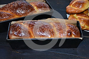 Cozonac. Romanian sweet bread. Traditional Christmas and Easter sweet bread dessert, called Cozonac in trays on a black