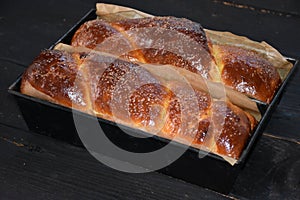Cozonac. Romanian sweet bread. Traditional Christmas and Easter sweet bread dessert, called Cozonac in trays on a black