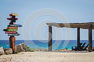 Cozumel distance sign and shaded chairs