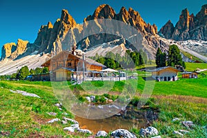 Cozy alpine chalets with mountain lake in Dolomites, Italy, Europe