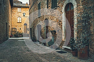 Cozy arranged street and decorated with colorful plants, Tuscany, Italy