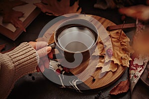 Cozy autumn composition with hot coffee and foliage