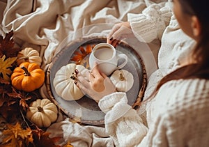 Cozy autumn at home,Woman drinking tasty pumpkin coffee on bed. A cozy way of life . AI Generated