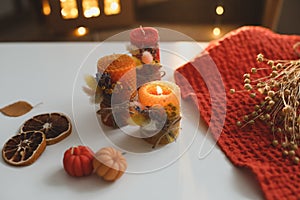 Cozy autumn hygge composition. still life with candle, leaves, pumpkin, textiles. Halloween, Thanksgiving. Flat lay, top view