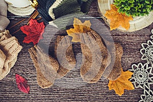 Cozy autumn still life with cup of hot black coffee. knitted hat and scarf on wooden background