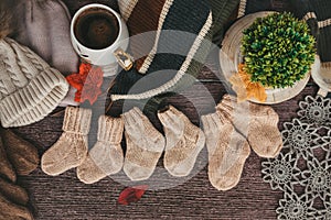 Cozy autumn still life with cup of hot black coffee. knitted hat and scarf on wooden background