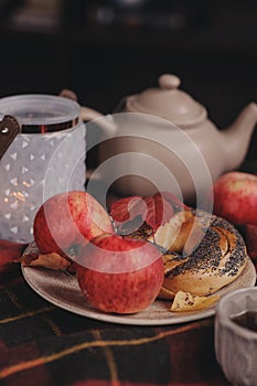 Cozy autumn weekend morning at home. Breakfast with cup of tea and bagel with apples