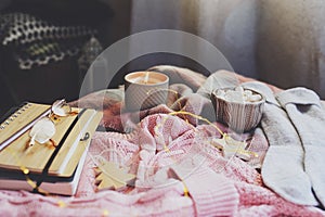 cozy autumn or winter morning at home. Still life details with cup of hot cocoa, candle, sketch book with herbarium and warm sweat