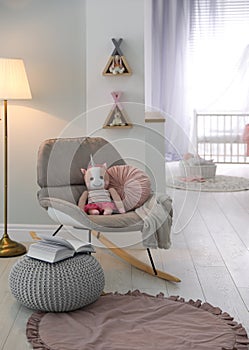 Cozy baby room interior with comfortable chair