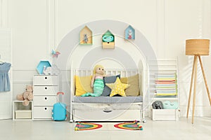 Cozy baby room interior with crib and toys