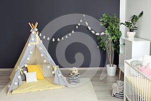 Cozy baby room interior with play tent