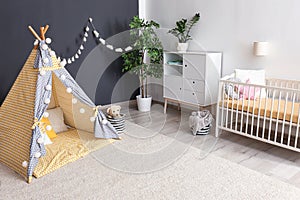 Cozy baby room interior with play tent