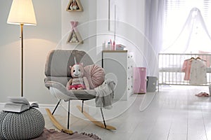 Cozy baby room interior with rocking chair