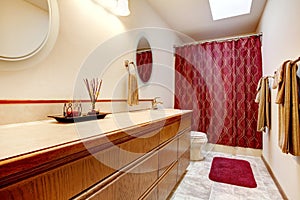 Cozy bathroom with red rug and curtains photo