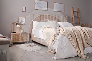 Cozy bed with soft linens in room