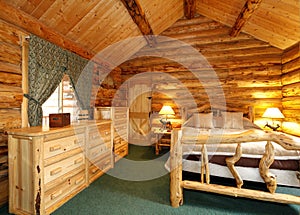 Cozy bedroom in log cabin house