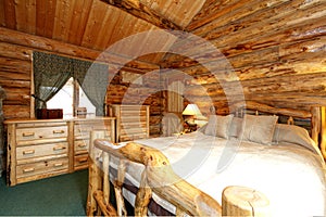 Cozy bedroom in log cabin house